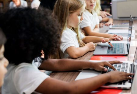 elementary school students on laptops