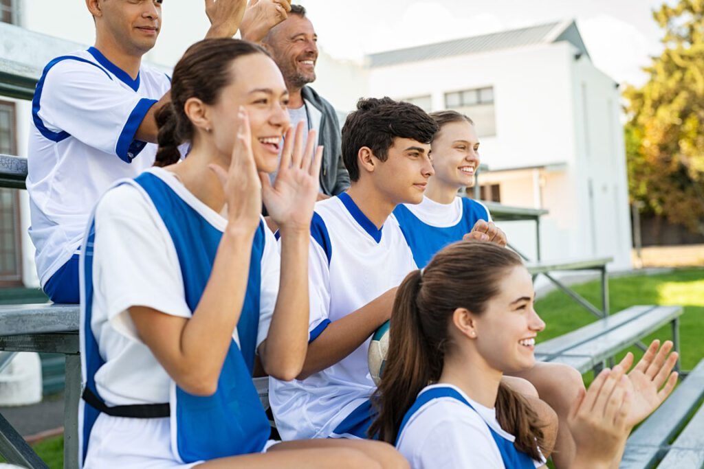 school sports team cheering from bench